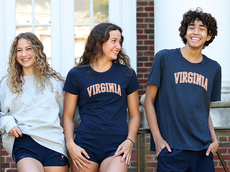 From the lululemon meets UVA collection three students wearing a combination of shorts a light gray sweatshirt and two different UVA blue tee shirts.