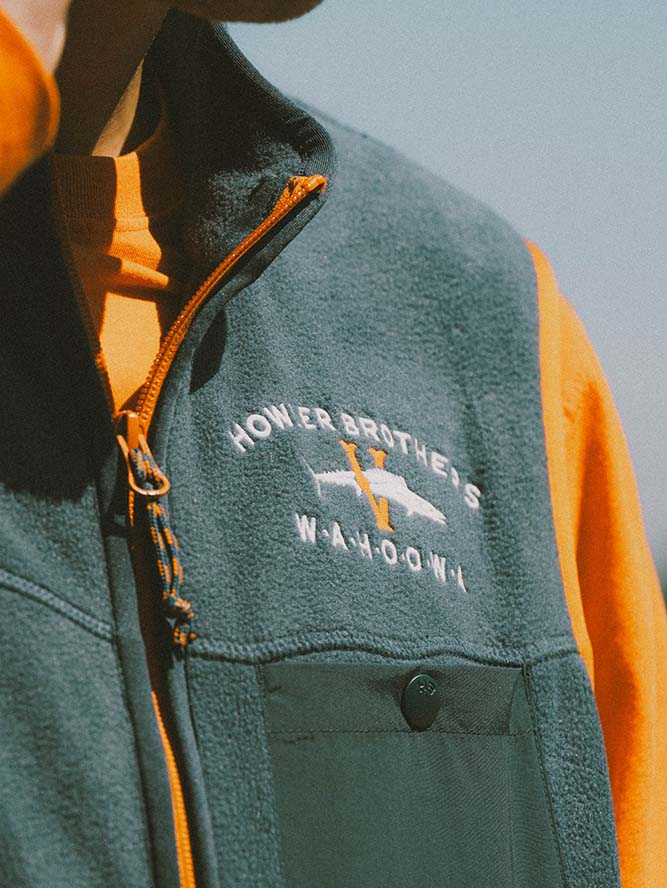 Close up of a blue Howler Bros. UVA fleece vest